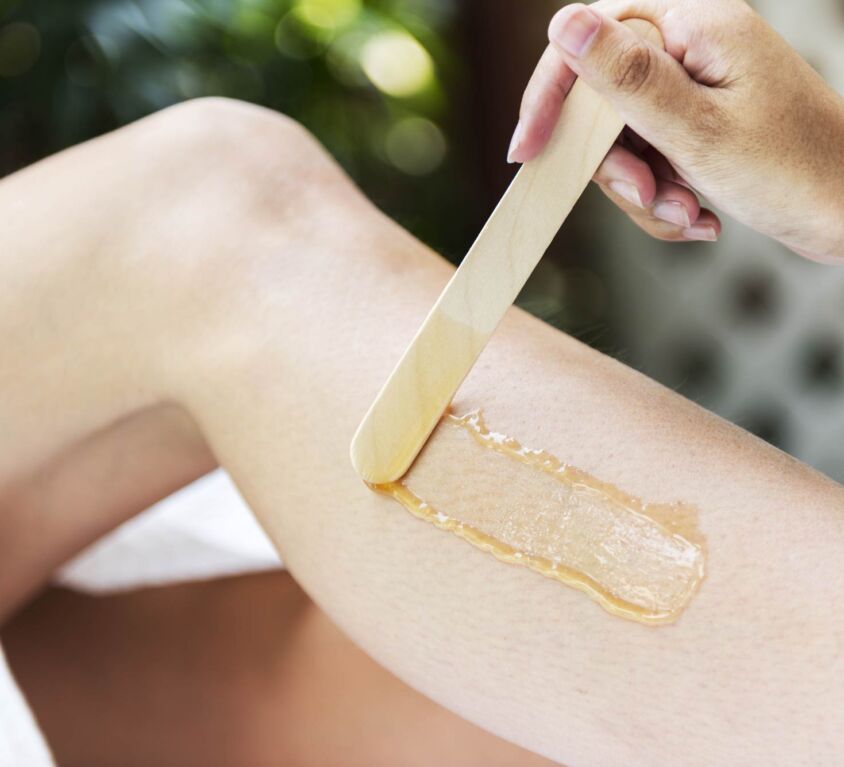woman-getting-legs-waxed-at-a-spa-PFWLHKD_low